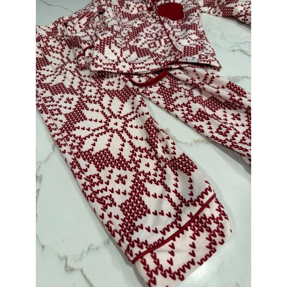 Sweet Honey pajama set features a festive red and white snowflake pattern 2T